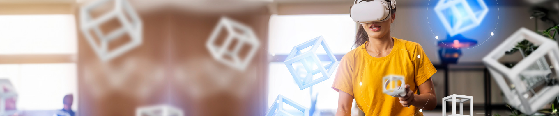 A person with a virtual reality viewer and controls, interacting with 3D cubes.