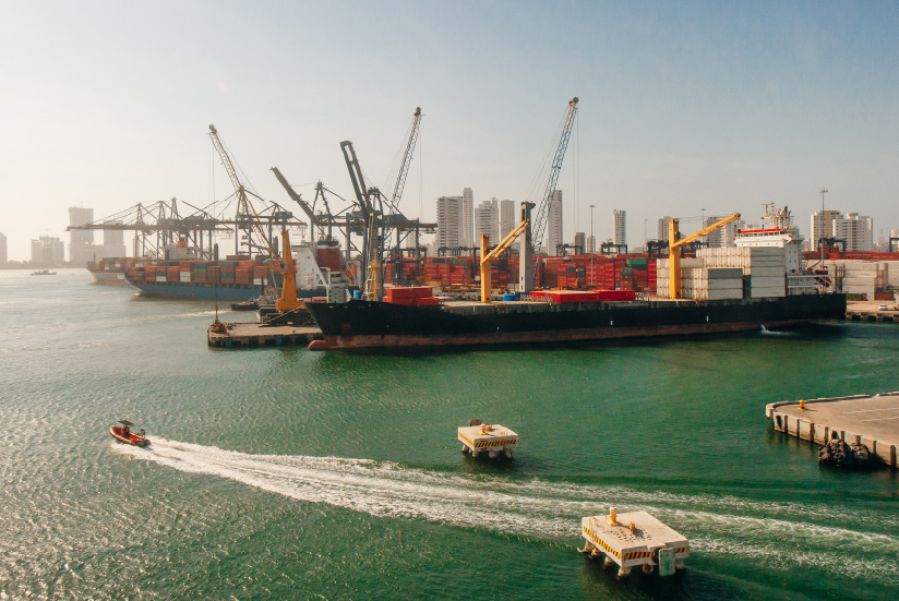 Port of Cartagena with container ships and cranes.
