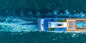 Aerial view of a catamaran sailing in blue waters.